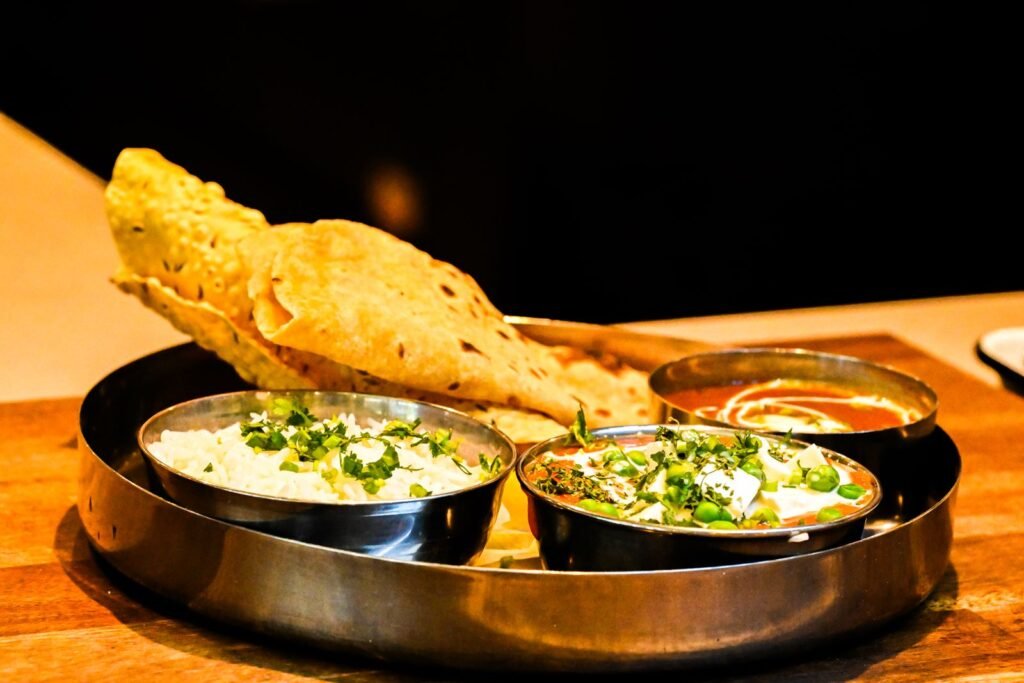An Indian thali with naan bread and curries