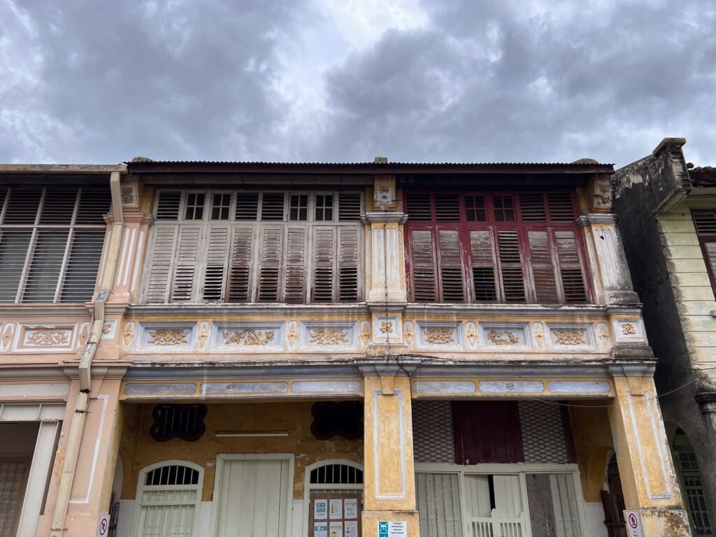 An ornate heritage shophouse facade in a Malaysian old town