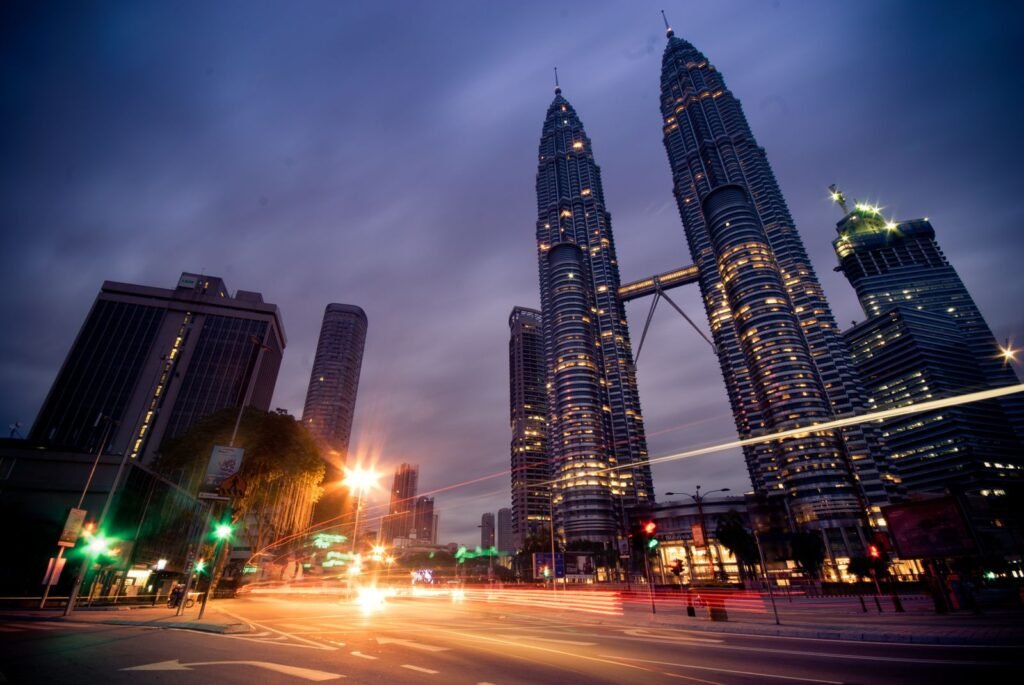 The Kuala Lumpur skyline lit up at night, seen from above