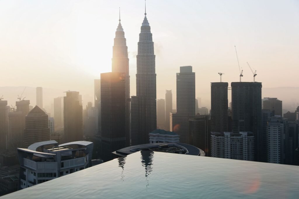 The Kuala Lumpur skyline with the Petronas Towers reflected in water