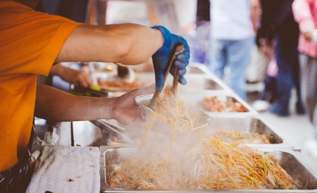 A street vendor serving freshly cooked noodles